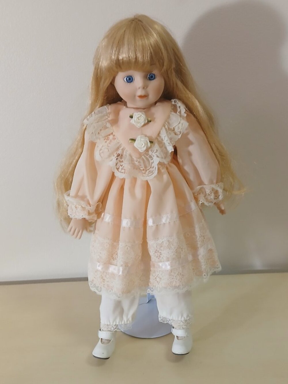Vintage porcelain doll with stand